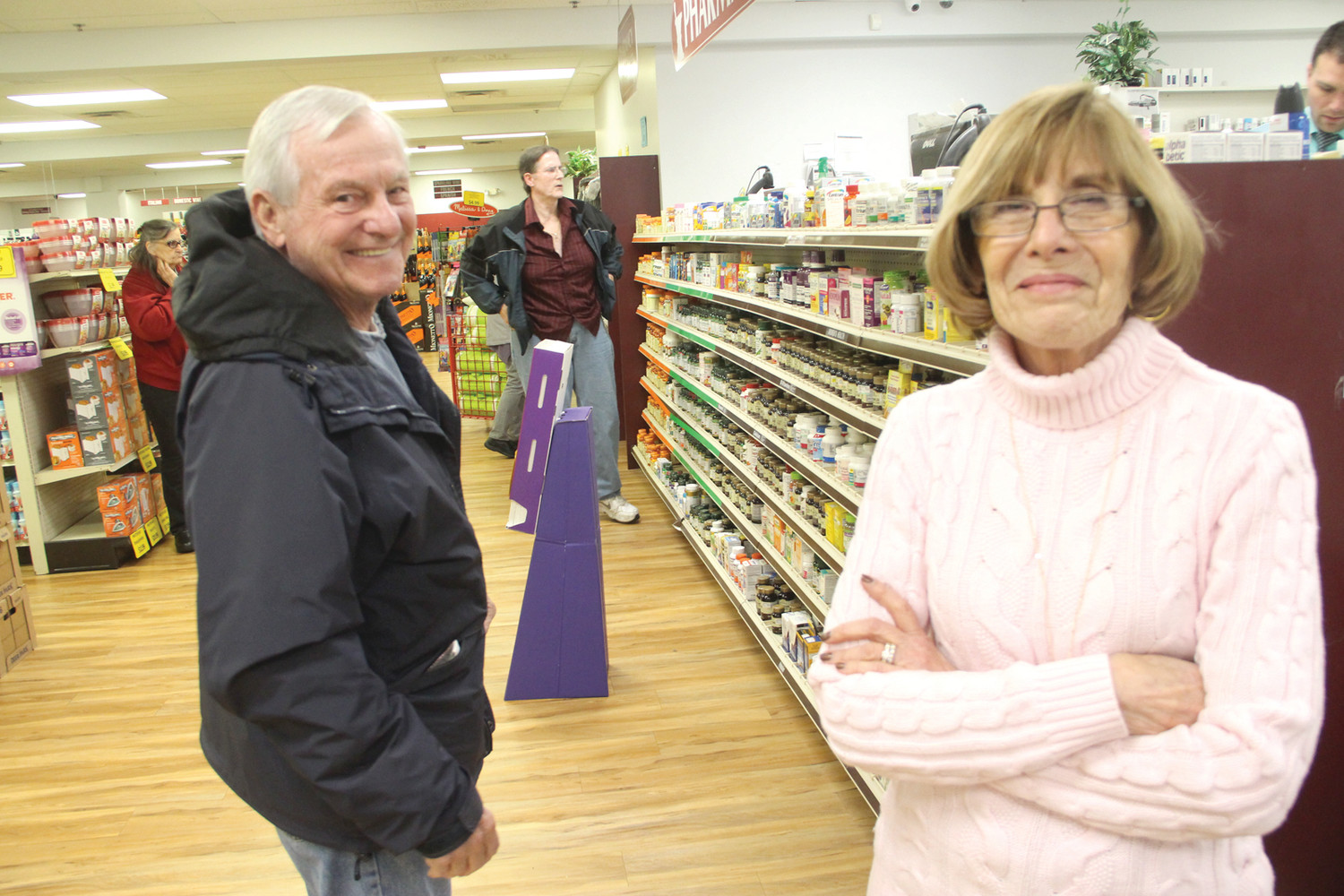 LIKE FAMILY: Jean Ricci, who has worked at Phred’s Drug for 38 years, talks with Teddy Scripsack in the store Tuesday. A retired Cranston firefighter now living in Barrington, Scripsack still comes to Phred’s.